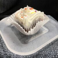 Chocolate cupcake with vanilla buttercream frosting and seasonal sprinkles. Chocolate Vanilla