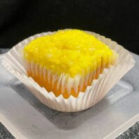 Lemon cupcake with lemon buttercream frosting topped with crushed lemon candies. Lemon