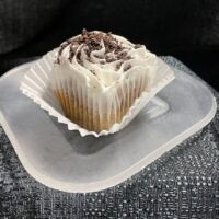 Oreo cupcake with vanilla buttercream frosting topped with Oreo crumbles. Oreo
