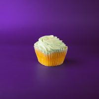 A lemon cupcake with a blueberry preserve filling, topped with blueberry buttercream and finished with yellow sanding sugar. Lemon Blueberry cupcake