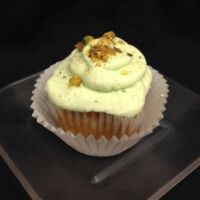 A pistachio cupcake filled with pistachio pudding, topped iced with pistachio cream cheese and finished with crushed pistachios. Pistachio