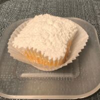 Poundcake cupcake topped with a dusting of powdered sugar. Poundcake