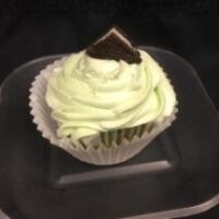 Mint Oreo cupcake frosted with green mint cream cheese then topped with 1/4 of a Oreo cookie. Grasshopper