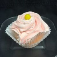 A pink lemonade cupcake filled with pink lemonade pie filling, topped with pink lemonade cream cheese and finished with a lemon head candy piece. Pink Lemonade