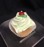 A lime cupcake with cherries filled with a non-dairy cherry filling, topped with lime buttercream and finished with 1/2 of a cherry and a piece of lime candy. Cherry Limeade