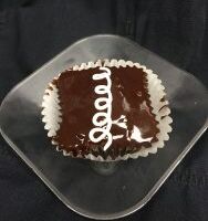 A chocolate cupcake with marshmallow filling, topped with chocolate ganache icing and finished with a white vanilla buttercream swirl. Hostess with the Mostest
