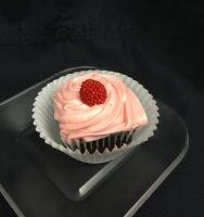 A dark chocolate raspberry cake iced with raspberry cream cheese frosting and then topped off with a raspberry candy piece. Dark Chocolate Raspberry