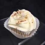 A pumpkin cupcake with a pumpkin pie filling baked in, topped with cream cheese icing and finished with a sprinkle of pumpkin pie spice. Pumpkin Pie