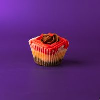 A brownie base topped with a strawberry cupcake, topped with chocolate buttercream and red colored strawberry cream cheese icing and finished with one red heart sprinkle...especially for your love! 1st Kiss cupcake