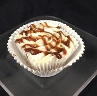 An apple butter cupcake with an apple butter filling, topped with cream cheese frosting and finished with an apple butter apple cider drizzle. Apple Butter
