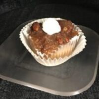 A butter pecan cupcake with pecan pie filling baked in topped with over flowing filling and finished with a small dollop of vanilla butter cream. Pecan Pie