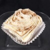 A pumpkin cupcake with a pumpkin pie filling baked in, topped with cream cheese icing and finished with a sprinkle of pumpkin pie spice. Pumpkin Pie