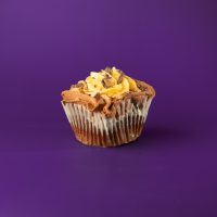 A chocolate cupcake filled with a sweet milk and heath bit mixture, topped with chocolate and caramel buttercream in a box style pattern, finished with heath candy bits. Toffee cupcake