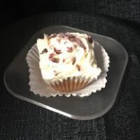 A cranberry, almond, white chocolate pound cupcake, iced in cream cheese frosting then topped with frosted cranberries. Frosted Cranberry