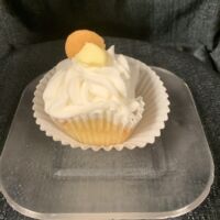 Banana cupcake filled with pudding, topped with pudding, and iced with vanilla buttercream and a Nilla Wafer. Banana Pudding