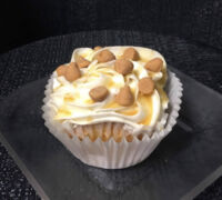 A butterscotch-filled butterscotch cupcake topped with cream cheese, finished with a butterscotch drizzle and butterscotch chips. Butterscotch