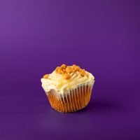 A butterscotch cupcake with a butterscotch filling, topped with cream cheese icing, finished with a butterscotch drizzle and butterscotch chips. Butterscotch cupcake