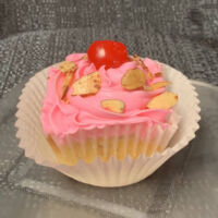 Almond cupcake with cherry cream cheese icing, topped with almonds and a marascino cherry. Cherry Almond
