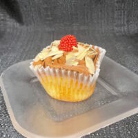 An almond cupcake with raspberry chocolate ganache filling, chocolate buttercream and finished with a candy raspberry and slivered almonds. Chocolate Almond Raspberry