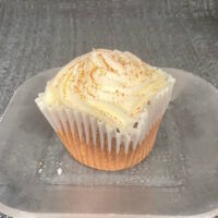 A chocolate cupcake topped with cream cheese icing and a sprinkle of cocoa powder. Chocolate Cream Cheese