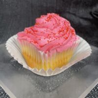 A cherry chip cupcake, topped with cherry cream cheese, and finished with red sanding sugar. Cherry Chip