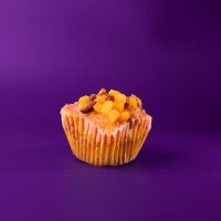 A Filipino inspired cheese cupcake baked with bacon with a strawberry preserve filling, strawberry glaze, and topped with bacon bits and cheese cubes. Strawberry Cheddar Bacon cupcake